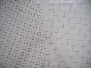 sheets of plastic with grids drawn onto them